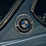 Close-up shot of a vintage BMW logo on a classic car. Iconic automotive detail.